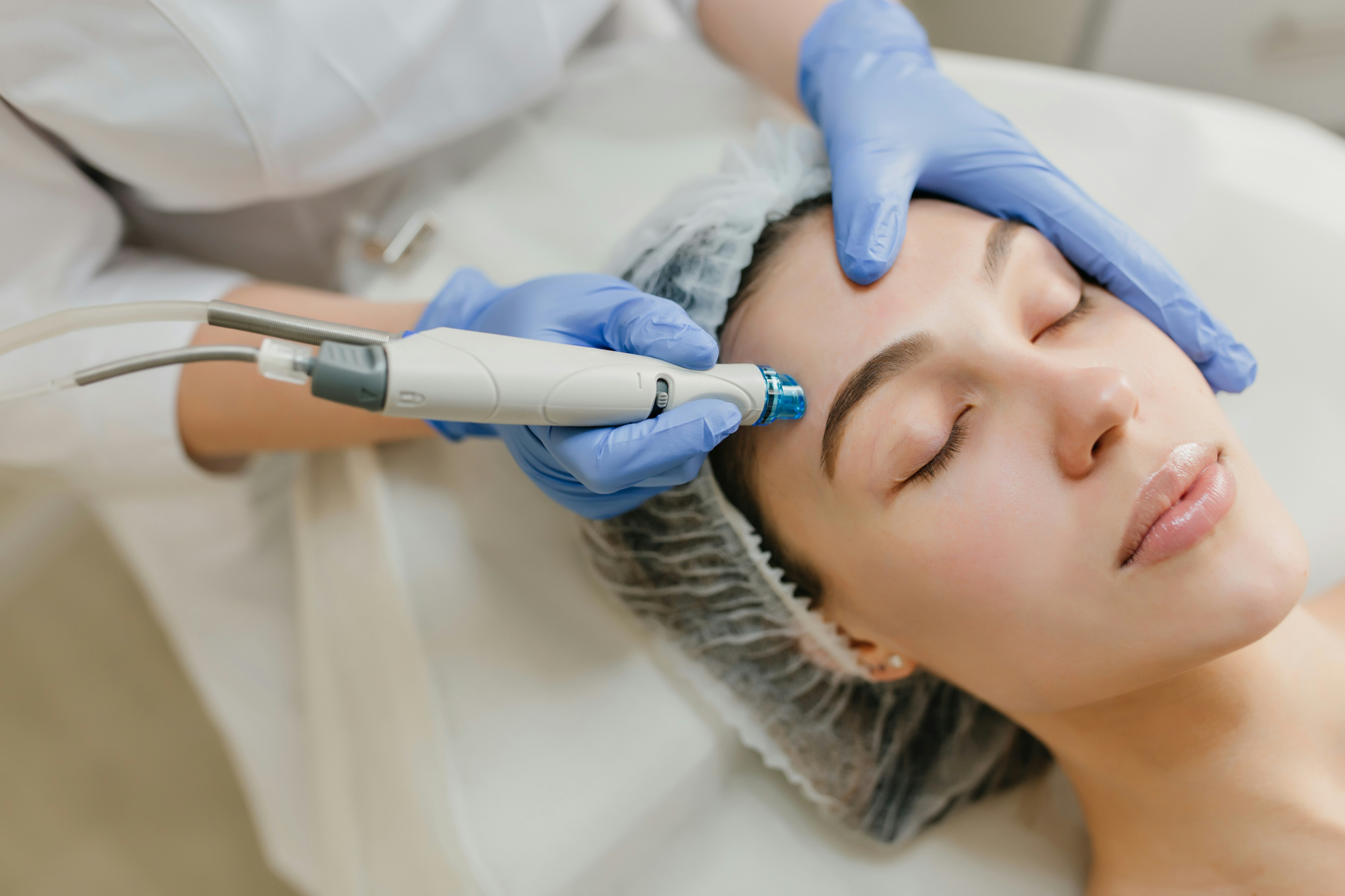 Board-certified injector performing a microdermabrasion treatment at an independent MedSpa, demonstrating the clinical depth and provider credentials that help local clinics get cited by ChatGPT over national chains